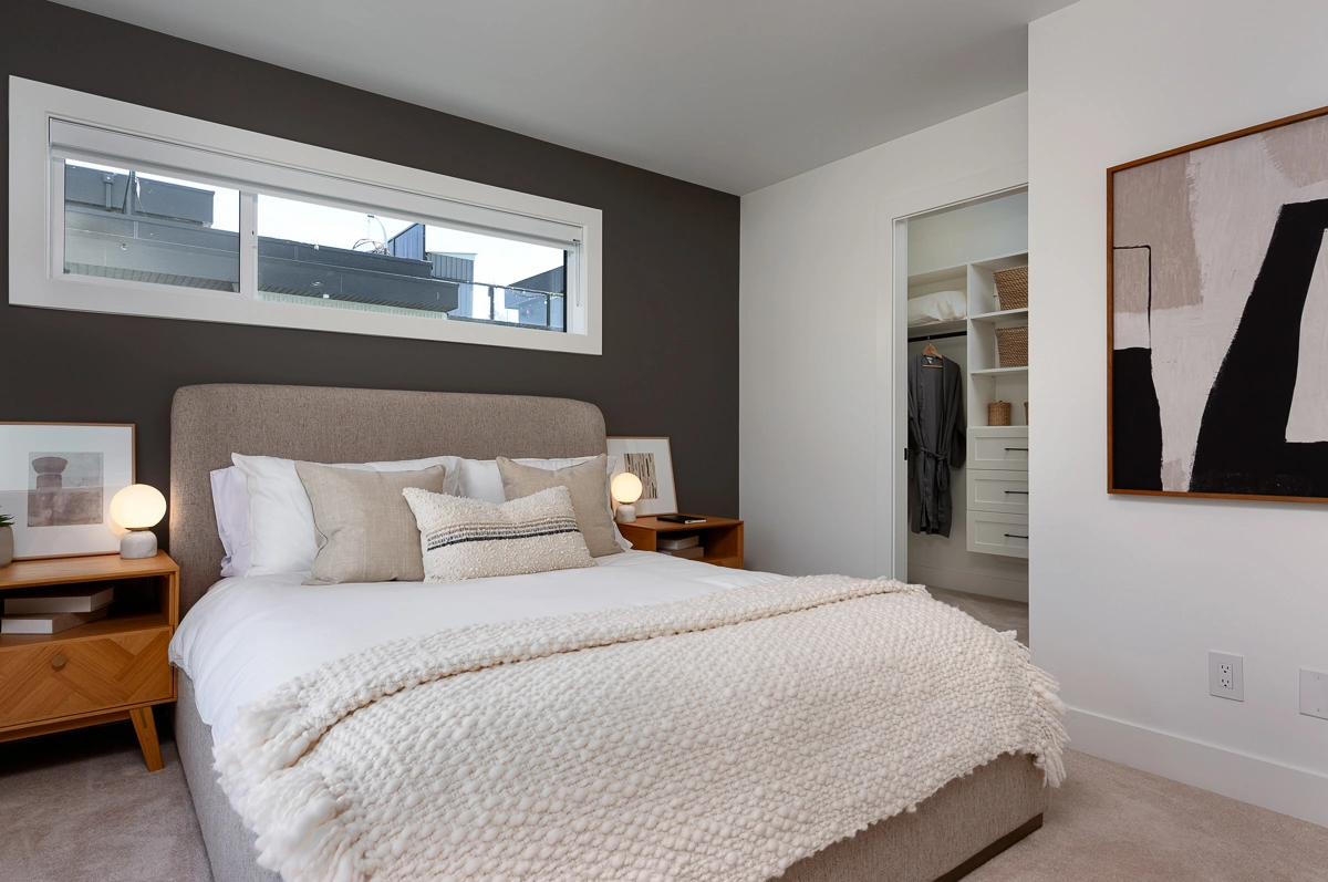 Plan A – primary bedroom with charcoal accent wall and walk-in closet