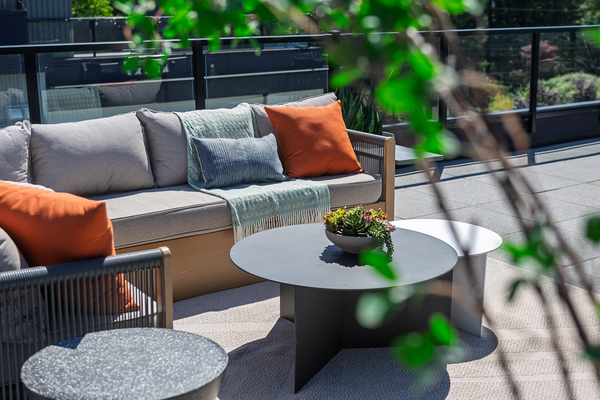 Plan A – rooftop lounge detail with cushioned sectional and planters