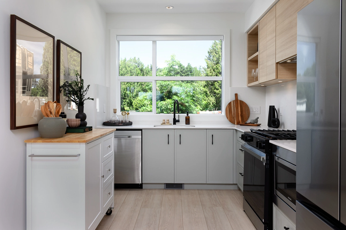 Plan B – kitchen with quartz counters, soft sage cabinetry, gas range and a window above the sink
