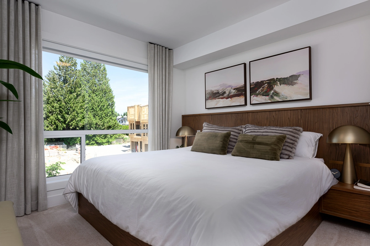 Plan B – primary bedroom with walnut headboard, king bed and a window overlooking the courtyard