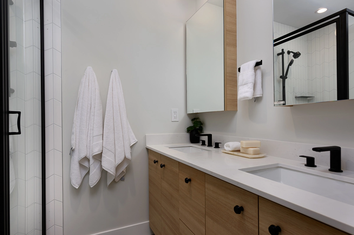 Plan B – ensuite with double quartz vanity, oak cabinetry, tiled walk-in shower and black fixtures